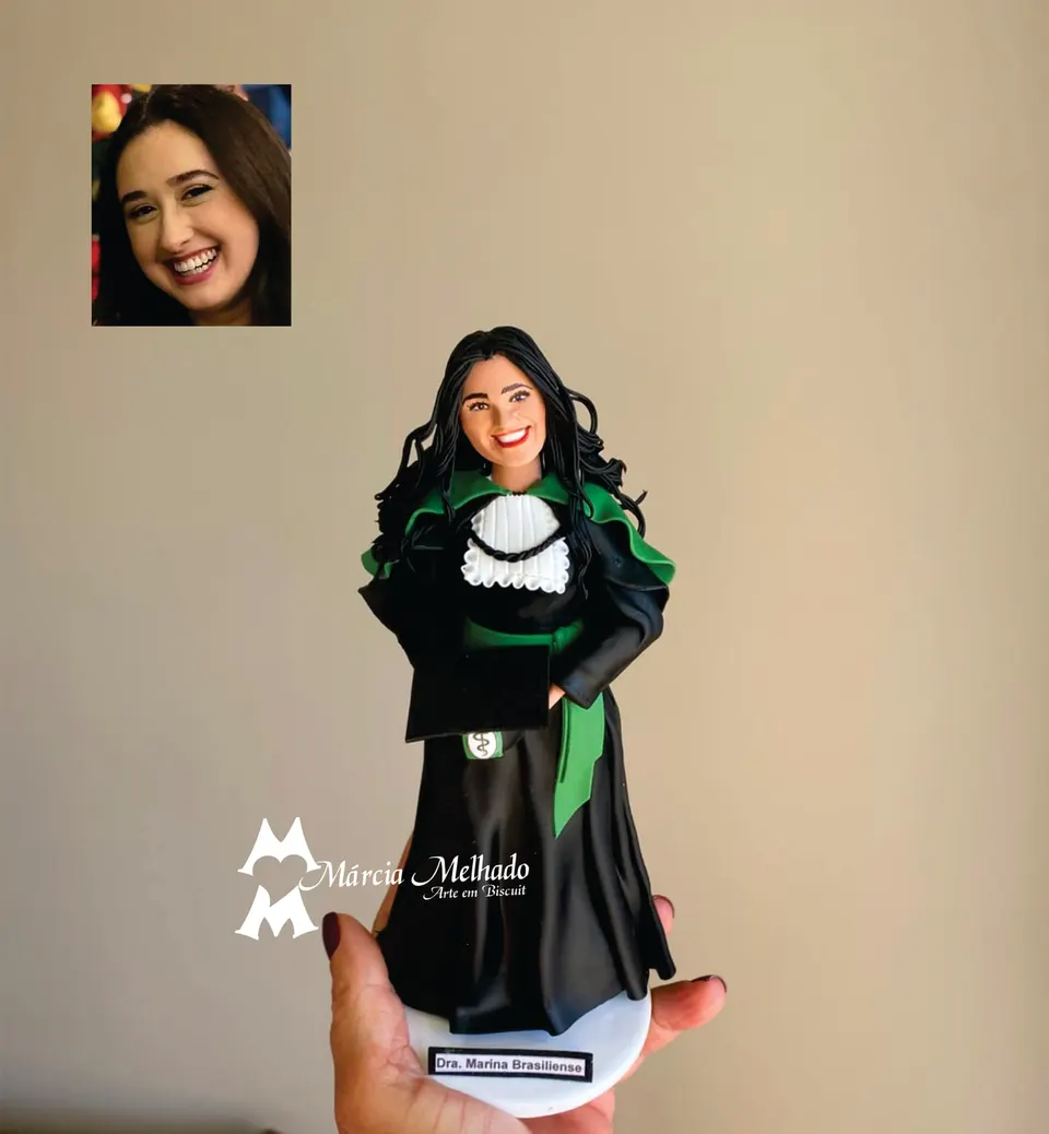Boneca de formatura em medicina com beca verde e canudo Boneca de biscuit de formanda em medicina com beca preta, faixa e capa verdes, jabô de renda e canudo de diploma