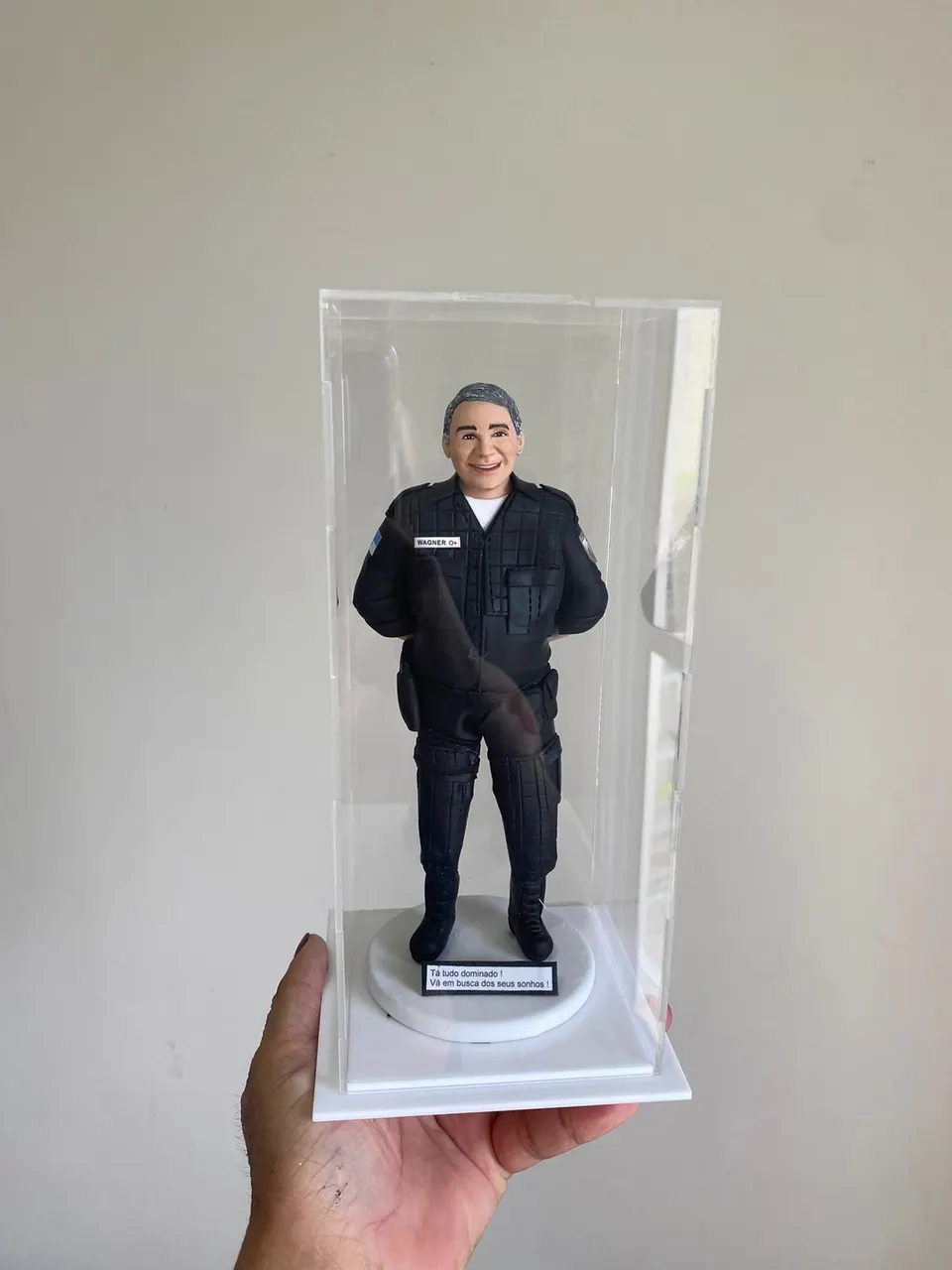 Boneco policial de farda tática preta com plaquinha em caixa de acrílico Boneco de biscuit de policial grisalho com farda tática preta, coldre e coturno dentro de caixa de acrílico