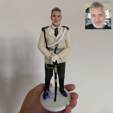 Boneco de biscuit de militar grisalho com túnica bege de gala, luvas brancas e espada apoiada à frente