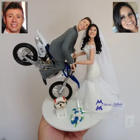 Noivinhos de biscuit: noivo de terno cinza empinando moto de motocross azul, noiva morena de vestido sereia e shih tzu